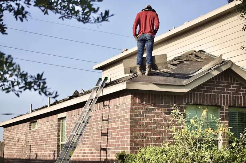Professional roofer working on a residential roof in Morse Park
